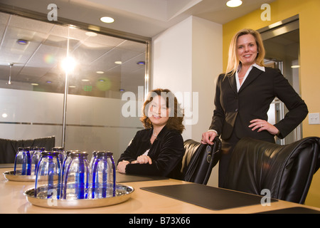 Two multi-racial businesswomen at table in boardroom Stock Photo