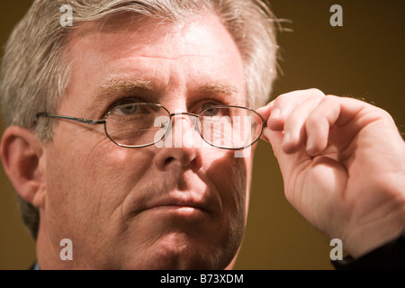 Face of midddle-aged businessman watching through eyeglasses Stock Photo