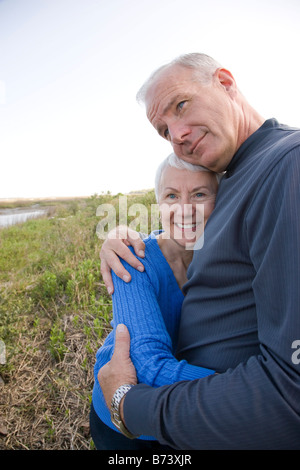 Senior couple hugging outdoors Stock Photo