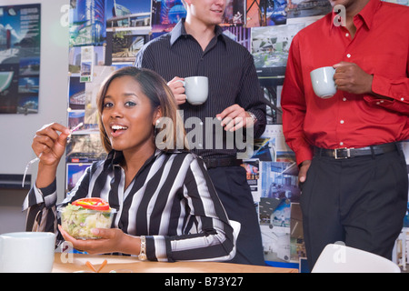 Office workers in meeting having a working lunch Stock Photo