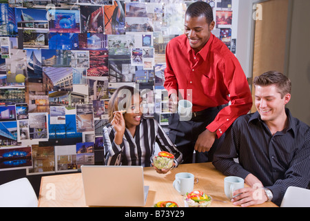 Office workers in meeting having a working lunch Stock Photo