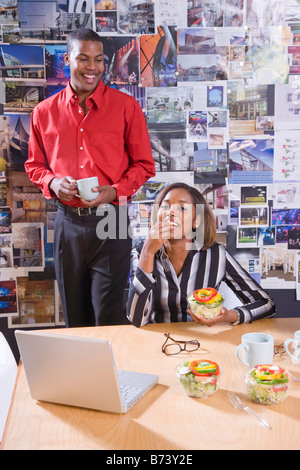 Office workers in meeting having a working lunch Stock Photo