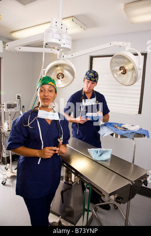 Two veterinarians in empty operating room Stock Photo
