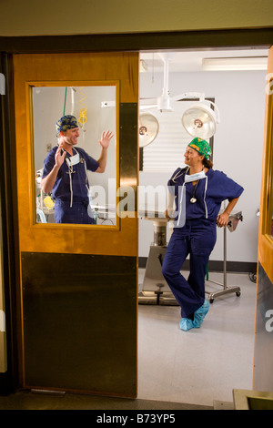 Veterinary surgeons talking in empty operating room Stock Photo