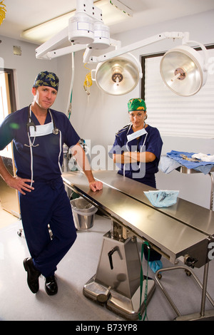 Two veterinary surgeons standing in empty operating room Stock Photo
