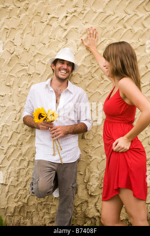 Young couple standing and talking outside Stock Photo
