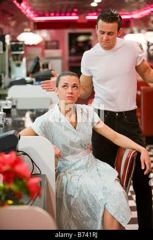 Young couple arguing in retro diner, 1950s style Stock Photo