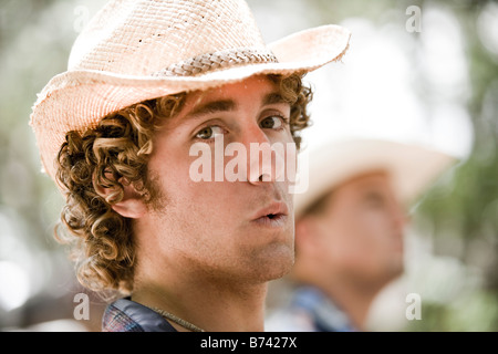 Face of young man wearing cowboy hat Stock Photo