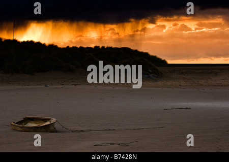 Rowing boat in the harbour before an evening storm at Barmouth Gwynedd North Wales Stock Photo