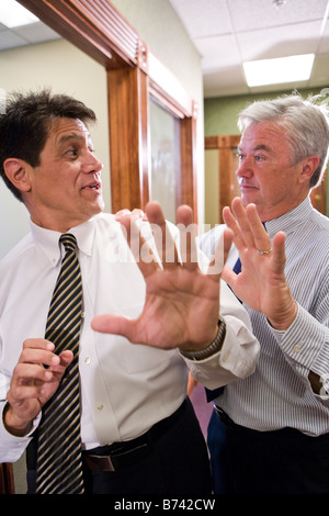 Two multi-ethnic businessmen having discussion in office corridor Stock Photo