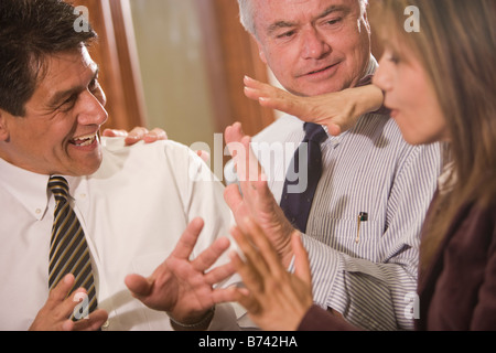 Three multi-racial businesspeople having discussion in office Stock Photo