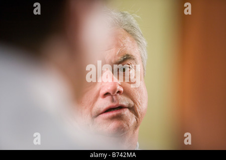 Two multi-racial businessmen conversing, partial view of face Stock Photo