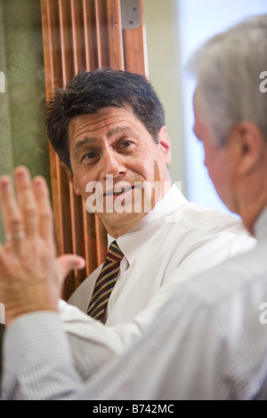 Two multi-racial businessmen having serious discussing Stock Photo