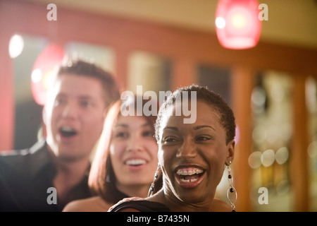Close-up of young African-American woman with friends Stock Photo