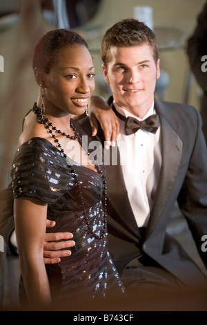 Young interracial couple wearing formal tuxedo and black dress Stock Photo