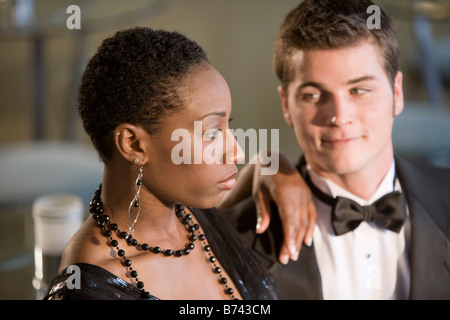 Young interracial couple wearing formal attire, focus on woman Stock Photo