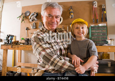 Happy grandfather and grandson in tool workshop Stock Photo
