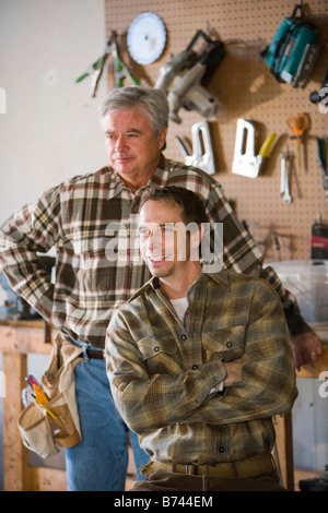 Senior man and mid-adult man in garage with tools Stock Photo