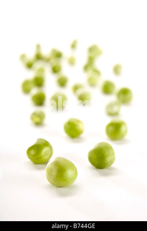 Close up of fresh garden peas - petit pois style, mini peas. Shot in modern shallow depth of field style. Stock Photo