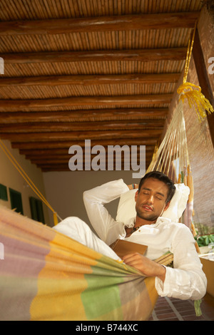 Man laying in hammock Stock Photo