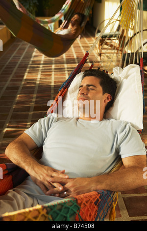 Man laying in hammock Stock Photo