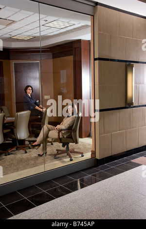 Businesswomen sitting in conference room Stock Photo