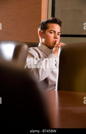 Businessman sitting in conference room Stock Photo