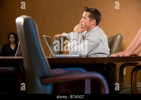 Profile of young businessman in meeting in conference room Stock Photo