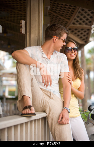 Close-up of young couple leaning on railing Stock Photo