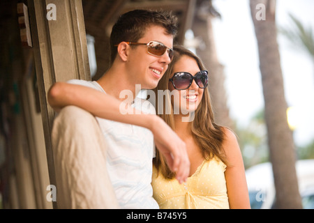 Close-up of young couple smiling, wearing sunglasses Stock Photo