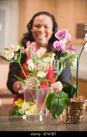 African American woman arranging flowers Stock Photo - Alamy
