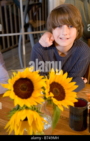 Portrait of twelve year old boy in dining room Stock Photo