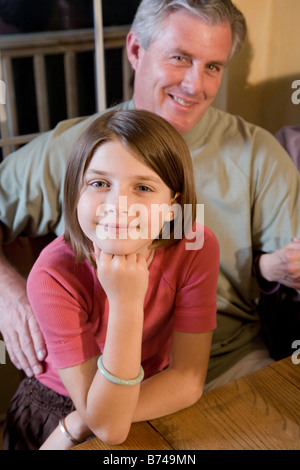 Portrait of father and daughter sitting together in dining room Stock Photo