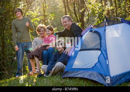 Portrait of family together on camping trip by tent Stock Photo