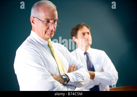 Close up of two executives standing with arms crossed Stock Photo