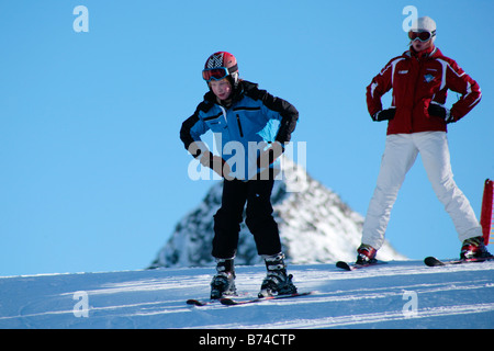 a young boy getting skiing lessons at mountain station Gamsgarten at Stubai Glacier in Tyrol, Austria Stock Photo