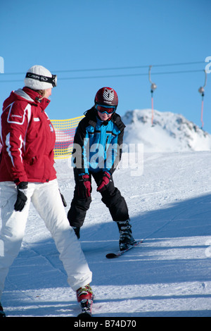 a young boy getting skiing lessons at mountain station Gamsgarten at Stubai Glacier in Tyrol, Austria Stock Photo