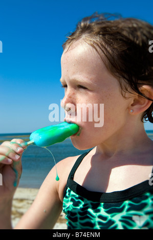 Girl Eating A Popsicle At The Beach Stock Photo - Alamy