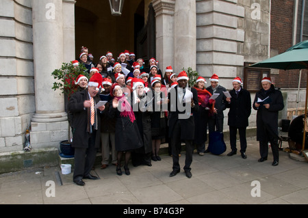 Carol singers outside St. Mary Le Bow Church, Cheapside, London, UK Stock Photo