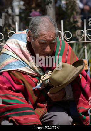 Elderly man asleep on a bench in Lamay, near Cusco, Peru Stock Photo