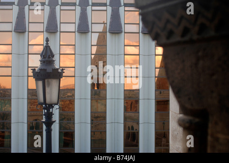 REFLECTION OF A SUNSET OVER THE FISHERMAN S BASTION IN BUDAPEST HUNGARY IN A MODERN GLASS BUILDING Stock Photo