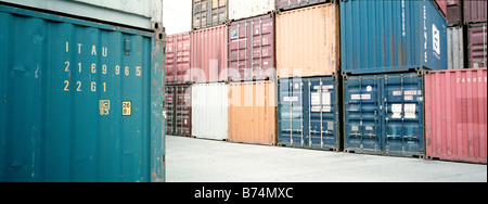 metal cargo shipping containers used by ship train and truck Stock Photo