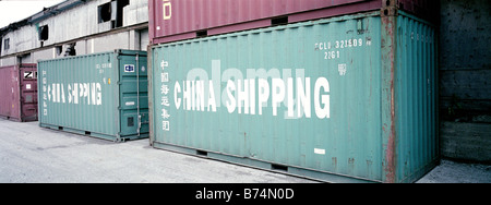 metal cargo shipping containers used by ship train and truck Stock Photo