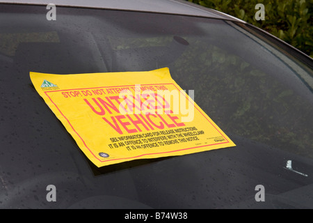 Untaxed Vehicle notice stuck on a car windscreen. Stock Photo