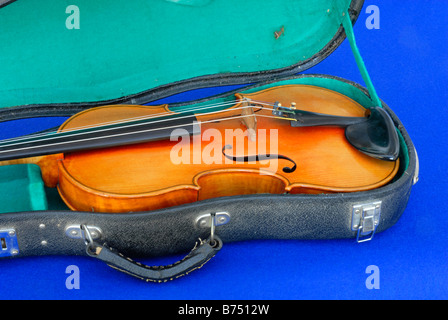 Violin in case, with blue background Stock Photo