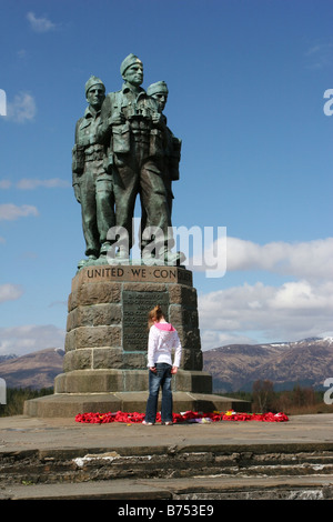 Youg girl reading wreaths at the Commando Memorial near Spean Bridge Stock Photo