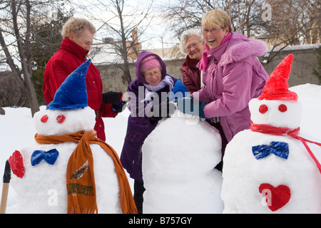Group of senior women making snowmen, Winnipeg, Canada Stock Photo