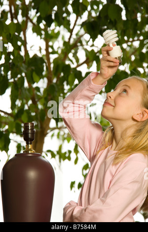 Young girl with an energy efficient light bulb, Toronto, Canada Stock Photo