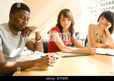Three students seated at table, solar panels in background, Winnipeg, Canada Stock Photo