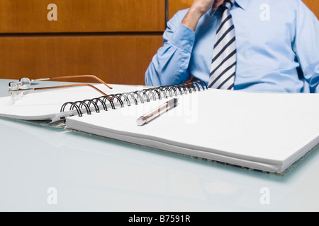 Mid section view of a businessman sitting in an office Stock Photo